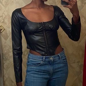 SIZE US 4 black top with corset-like waist. Faux leather material from PLT